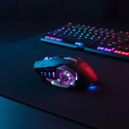 Gaming mouse and keyboard with RGB lighting on a dark surface
